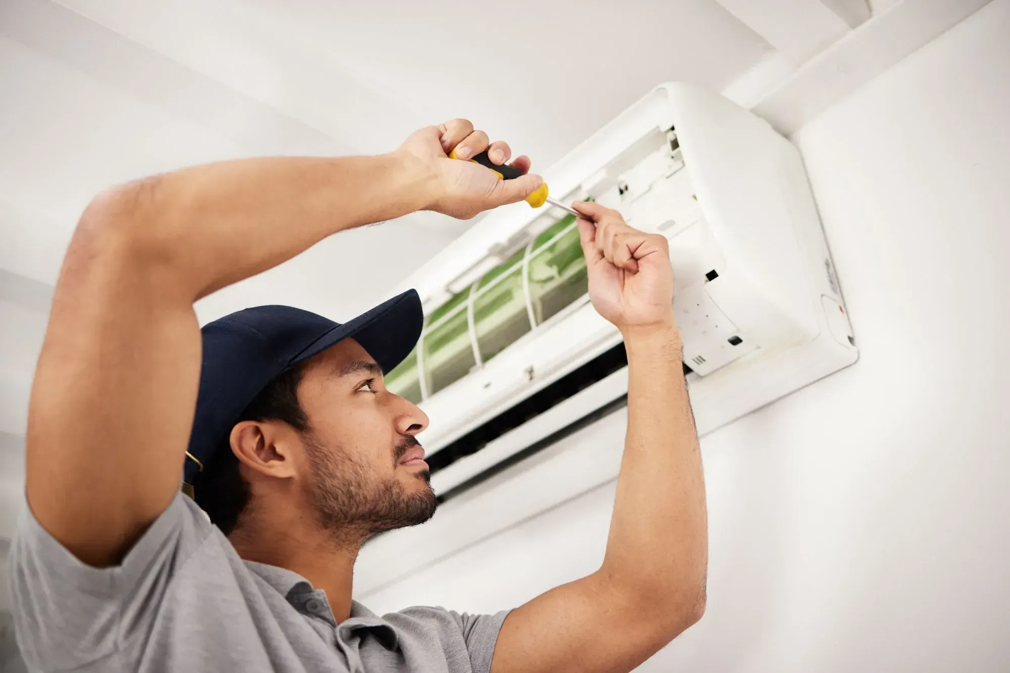 Accolade Heating technician performing an AC tune-up at a Surrey BC home