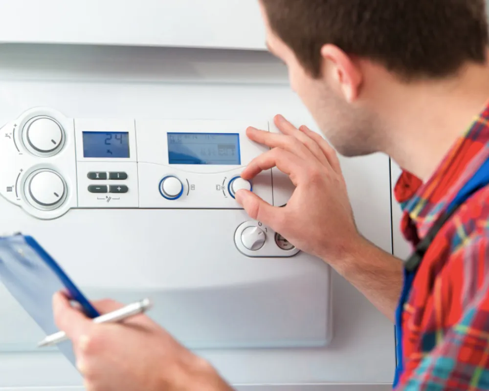 Accolade Heating technician performing annual boiler maintenance at a Surrey BC home