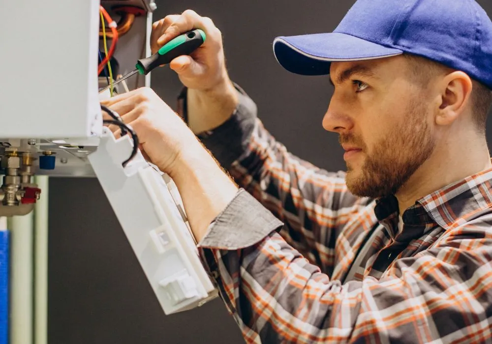 Accolade TECA-certified technician installing a heat pump in a Surrey BC home