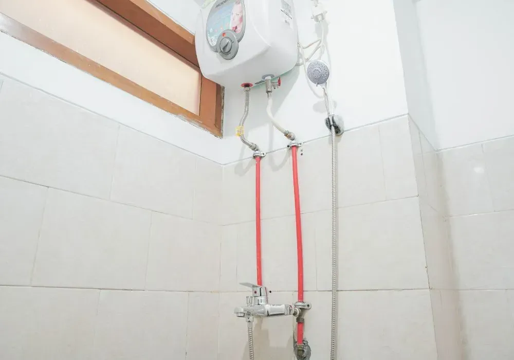 Accolade Heating technician installing a water heater in a Surrey BC home